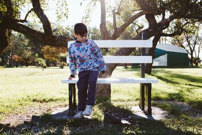 Boy sitting on a park bench
