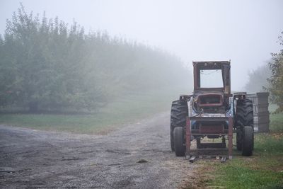 Lifeguard hut on field against sky during foggy weather