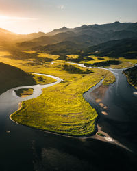 High angle view of lake and mountains against sky