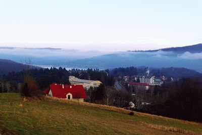 Houses on field against sky