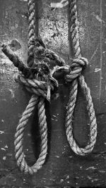 Close-up of rope tied up on chain