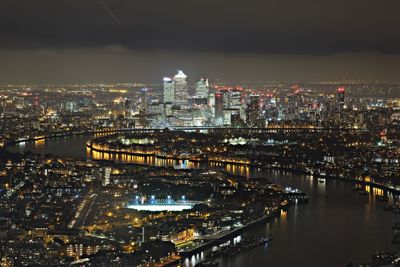 Aerial view of city lit up at night