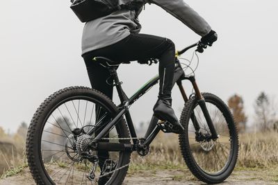 Low section of man riding bicycle