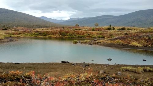 Scenic view of lake and mountains against sky