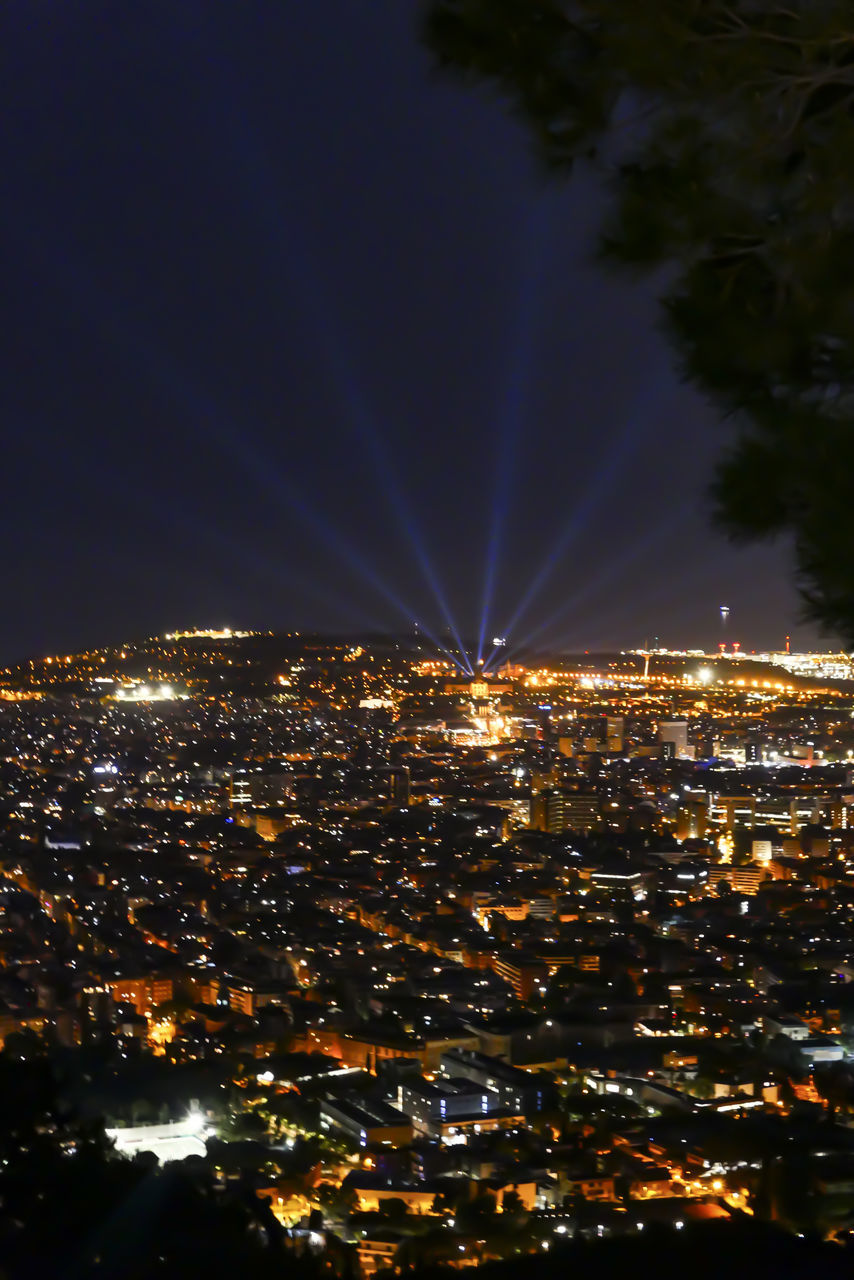 ILLUMINATED BUILDINGS AGAINST SKY AT NIGHT