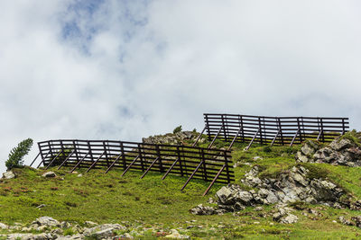 Avalanche protection fences in the alpine mountains. steel snow bridges, sliding snow stands, summer