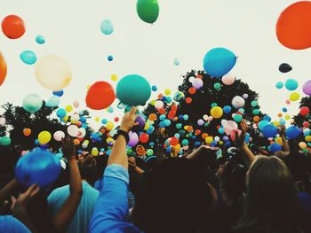 Multi colored balloons against sky