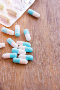 Pills spilling from bottle on table