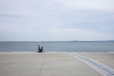 People on sea against sky