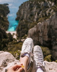 Low section of person standing on rock