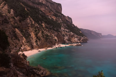 Scenic view of sea and mountains against sky