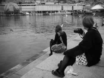 Full length of woman sitting on bench