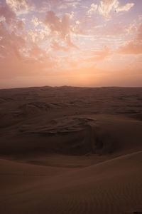 Scenic view of desert against sky during sunset