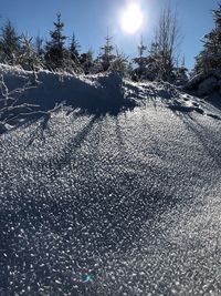 Scenic view of snow covered land against sky