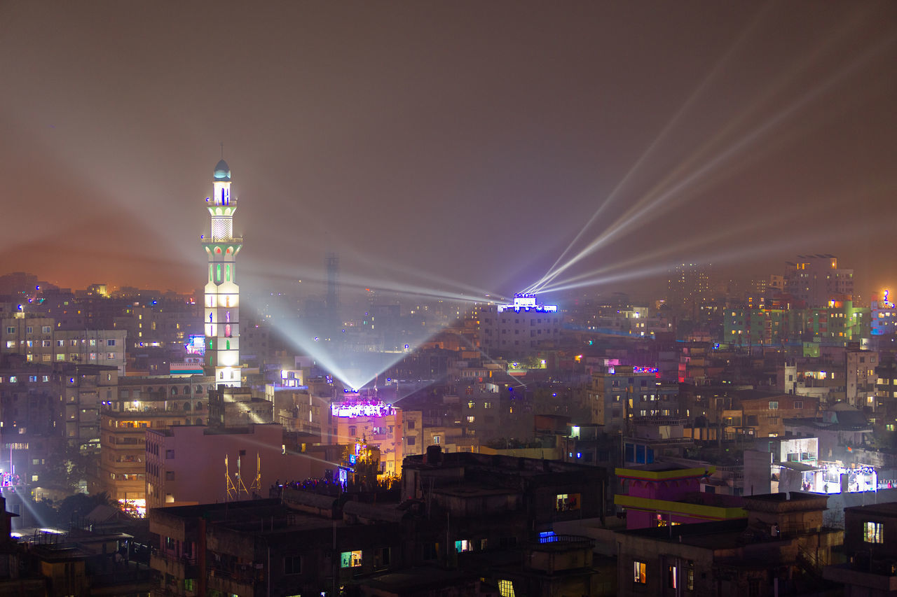 ILLUMINATED CITY BUILDINGS AGAINST SKY AT NIGHT