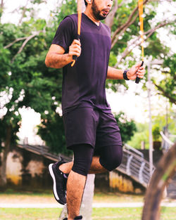 Man using jumping rope outdoors. copy space.