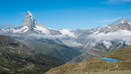 Scenic view of snowcapped mountains against sky