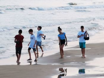 Rear view of people on beach