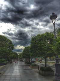 Street light against cloudy sky