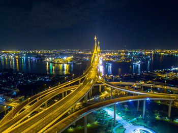 High angle view of city lit up at night