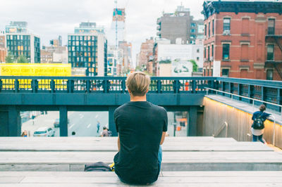 Rear view of woman standing in city