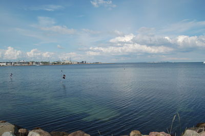 Scenic view of sea against cloudy sky