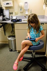 Girl sitting on seat at home