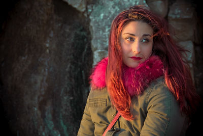 Beautiful redhead woman against rock formation