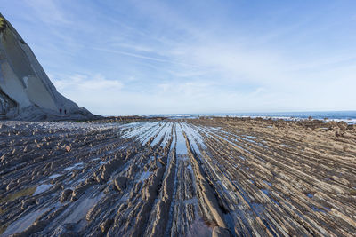 Scenic view of beach against sky during winter