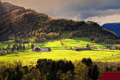 High angle view of houses on field against mountain