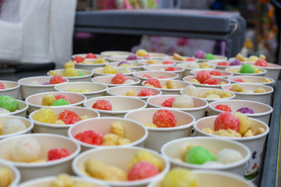 View of ice cream cups with colorful cakes in the market in vietnam
