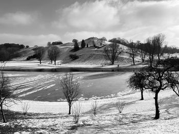 Scenic view of lake against sky during winter