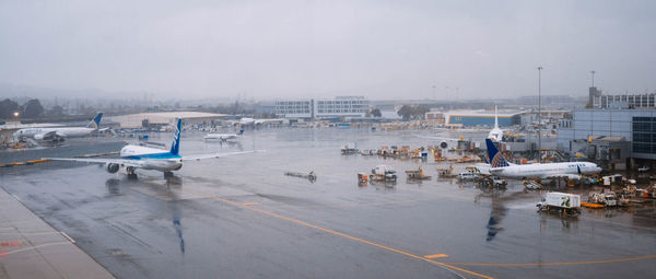 High angle view of wet airport runway against sky during rainy season