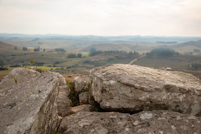 Scenic view of rocks on land against sky