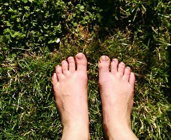 Feet on grassy landscape