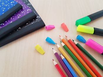 Colorful pencils and felt tip pens on table