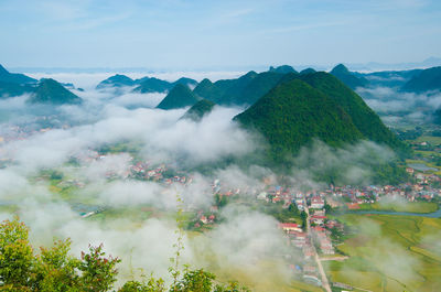 High angle view of trees and mountains against sky