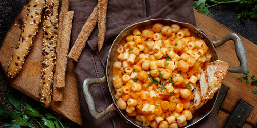 Directly above shot of pasta in container over cutting board