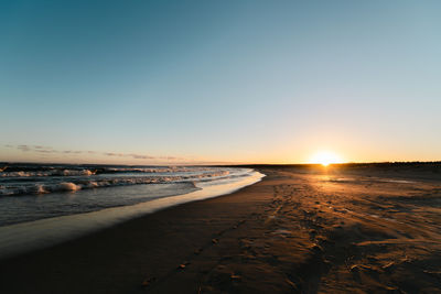 Scenic view of sea against clear sky during sunset