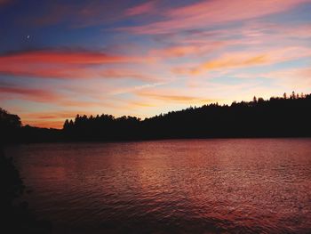 Scenic view of lake against orange sky