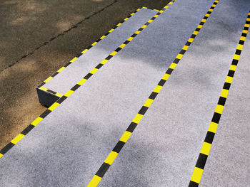 High angle view of stairs with yellow and black striped tapes for safety caution