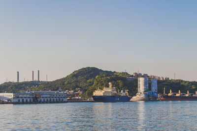 Boats in river with buildings in background