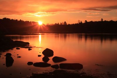 Sunrise over calm water - lysaker