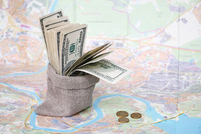 Close-up of paper currency in sack on map