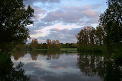 Scenic view of lake against cloudy sky