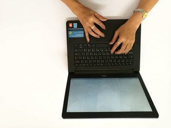 Low section of woman using laptop on table