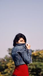 Portrait of boy standing against clear sky