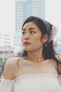 Portrait of beautiful young woman looking away