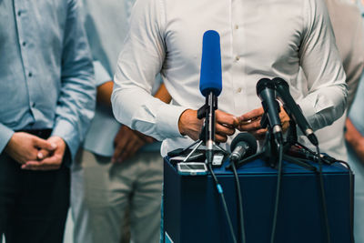 Midsection of businessman giving interview