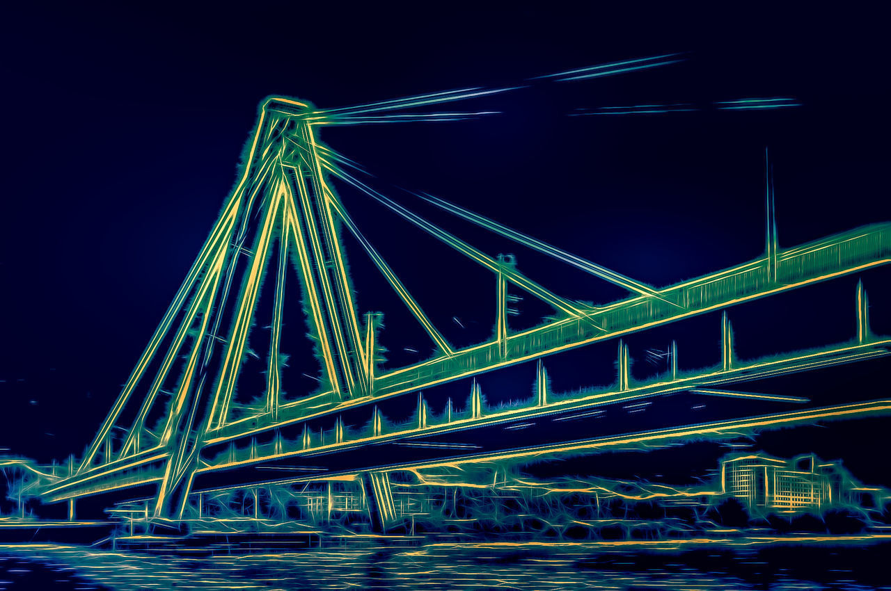 LOW ANGLE VIEW OF ILLUMINATED BRIDGE AGAINST SKY